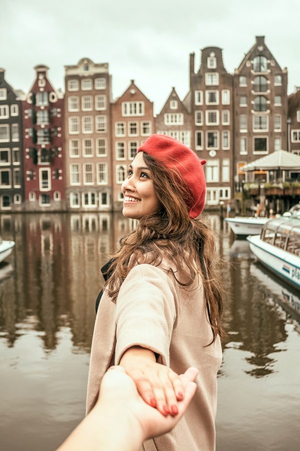 Amsterdam solo traveler holding hands.