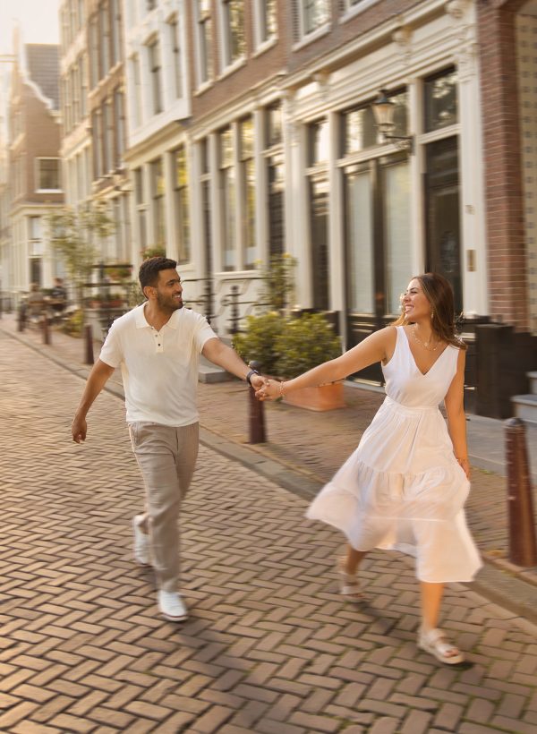 An engaged couple taking a stroll through Amsterdam streets.
