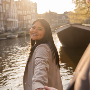 A woman smiles because she has just been proposed in Amsterdam.
