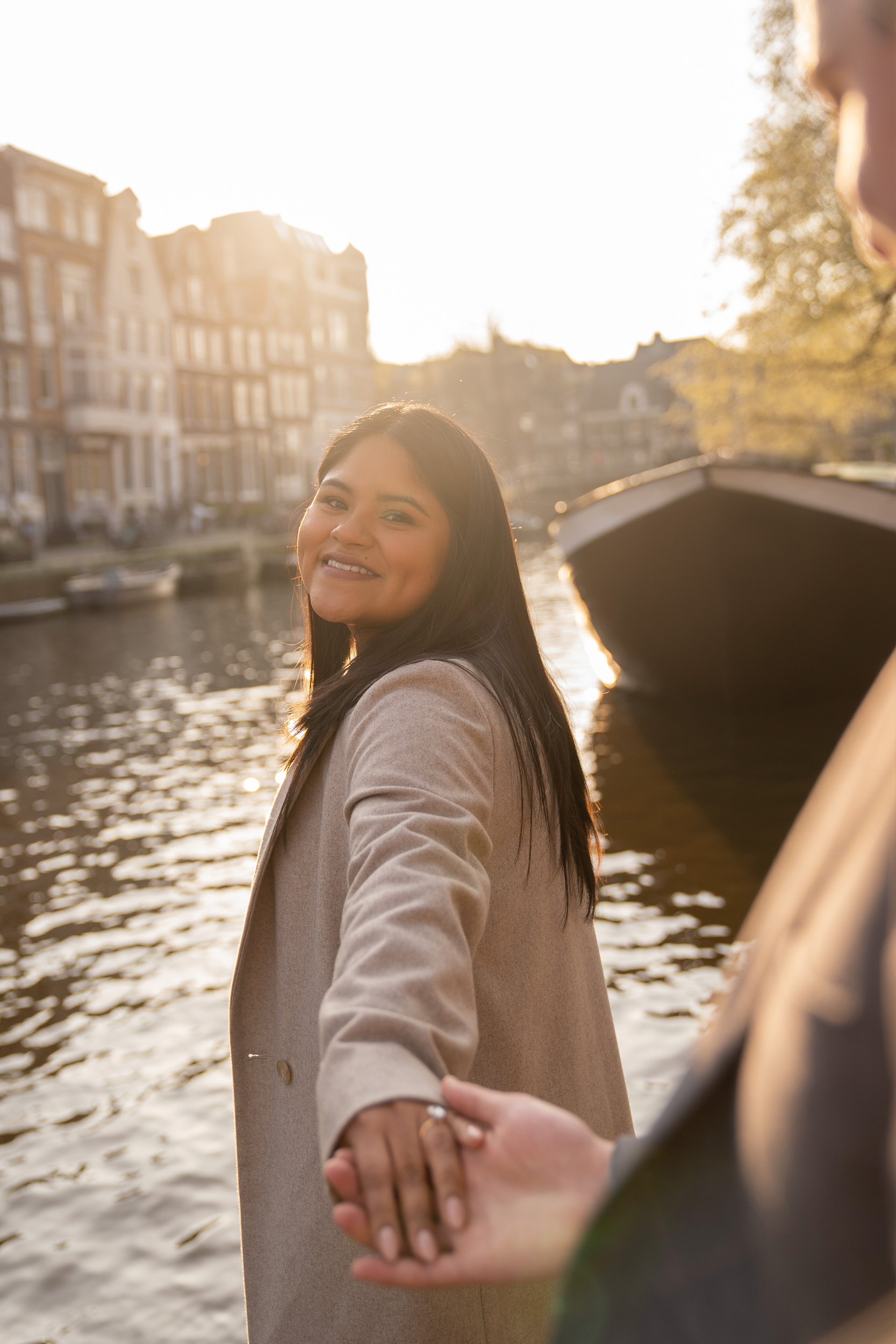 A woman smiles because she has just been proposed in Amsterdam.