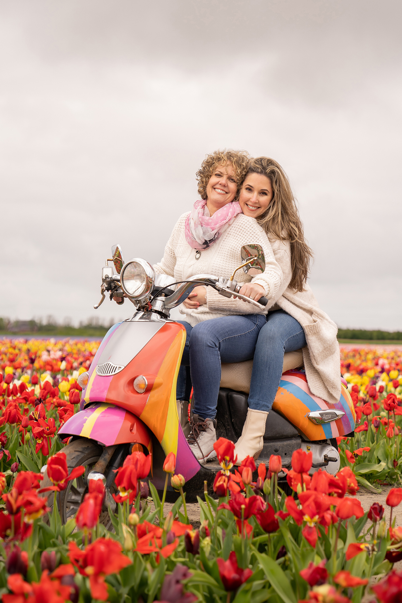 Tulip fields photo of a lesbian couple on a motorcycle in a tulip garden in the Netherlands.